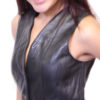 A woman wearing the Women Vest Black Genuine Leather Nice Fit 527 lm and red pants.