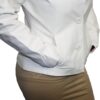 A woman wearing a Women's Soft Genuine White Leather Short Buttons Closure Fitted Jacket Style and tan skirt.