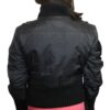 The back view of a woman wearing a Women's Rabbit Fur with Trim/Knitting Rib Jacket Black Special and pink skirt.