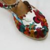 A pair of Women Genuine Leather Espadrille Wedges Mexican Sandals with White Flower Paint.