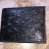 A black Genuine Ostrich Skin Leather Men's Bifold Wallet Made in USA - Best Prices with ostrich skin on it.