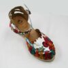 A pair of Women Genuine Leather Espadrille Wedges Mexican Sandals with White Flower Paint with a colorful floral pattern.