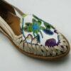A pair of Ladies Genuine Authentic Mexican Leather Flower Print Closed Toe Flat Sandals-1 with colorful flowers on them.