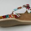 A pair of Women Genuine Leather Espadrille Wedges Mexican Sandals with White Flower Paint with a colorful pattern.