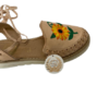 A pair of Women Wrap Up Sandals Genuine Authentic Mexican Beige Leather Handcrafted with a sunflower embroidered on them.